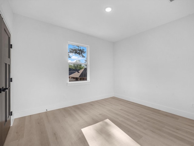 10732 Twin Oaks Dr, Conroe, TX 77385 - unfurnished room with light wood finished floors, baseboards, and recessed lighting
