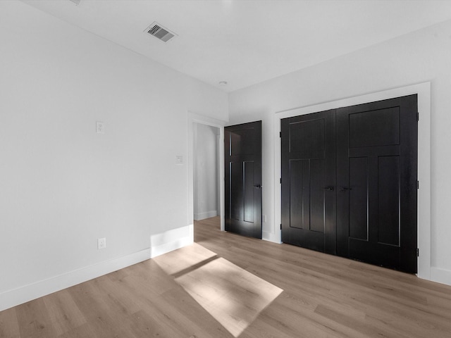 10732 Twin Oaks Dr, Conroe, TX 77385 - unfurnished bedroom featuring light wood finished floors, a closet, and baseboards