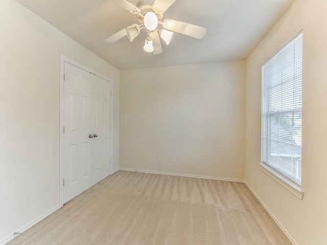 24247 Silversmith Ln, Katy, TX 77493 - spare room featuring light carpet, ceiling fan, and baseboards