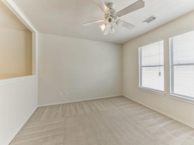 24247 Silversmith Ln, Katy, TX 77493 - unfurnished room with light carpet, a ceiling fan, and baseboards