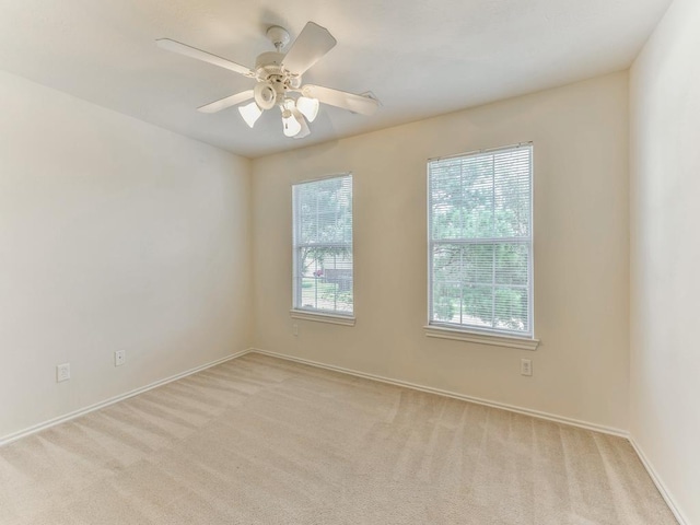 24247 Silversmith Ln, Katy, TX 77493 - empty room with light colored carpet, ceiling fan, and baseboards