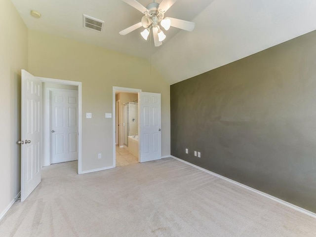 24247 Silversmith Ln, Katy, TX 77493 - unfurnished bedroom with light carpet, lofted ceiling, baseboards, ceiling fan, and ensuite bath