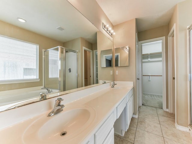 24247 Silversmith Ln, Katy, TX 77493 - full bathroom with a stall shower, tile patterned floors, double vanity, baseboards, and a walk in closet