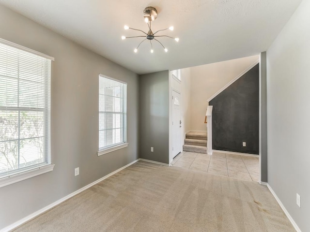 24247 Silversmith Ln, Katy, TX 77493 - unfurnished living room with a chandelier, healthy amount of natural light, carpet flooring, and stairway