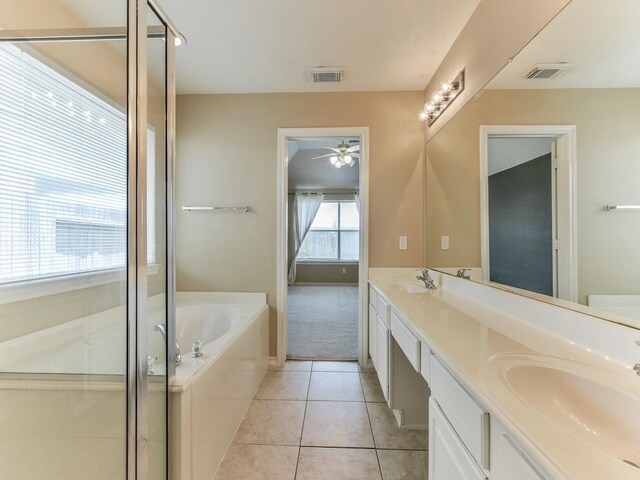 24247 Silversmith Ln, Katy, TX 77493 - bathroom with ceiling fan, a bath, tile patterned flooring, double vanity, and a stall shower