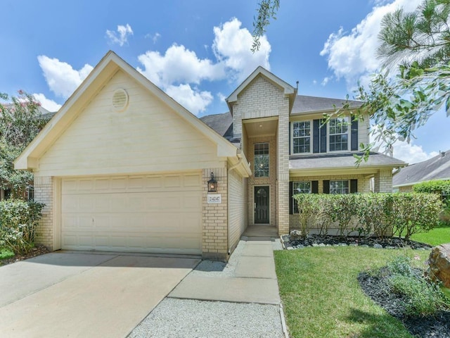 24247 Silversmith Ln, Katy, TX 77493 - view of front of home with brick siding, driveway, a garage, and a front lawn