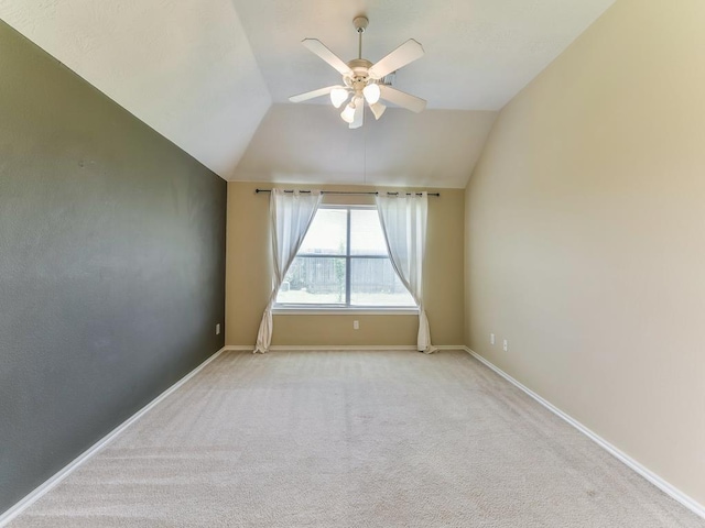 24247 Silversmith Ln, Katy, TX 77493 - carpeted spare room with a ceiling fan, vaulted ceiling, and baseboards