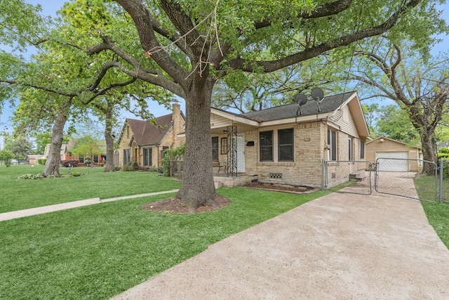 512 Gale St, Houston, TX 77009 - view of front facade featuring a gate, brick siding, concrete driveway, a detached garage, and an outbuilding