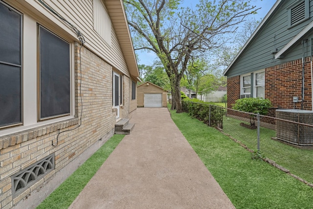 512 Gale St, Houston, TX 77009 - view of yard featuring central air condition unit, a garage, concrete driveway, and an outdoor structure