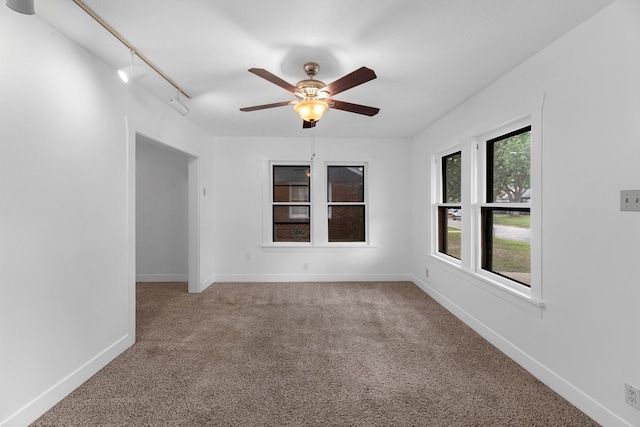 512 Gale St, Houston, TX 77009 - empty room featuring carpet floors, a ceiling fan, baseboards, and rail lighting