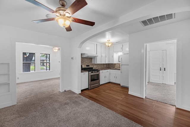 512 Gale St, Houston, TX 77009 - kitchen featuring stainless steel gas stove, freestanding refrigerator, ceiling fan, under cabinet range hood, and white cabinetry