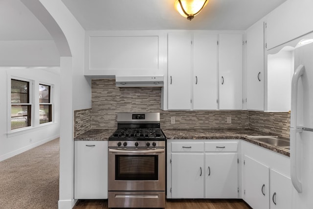 512 Gale St, Houston, TX 77009 - kitchen with gas range, under cabinet range hood, freestanding refrigerator, and white cabinets