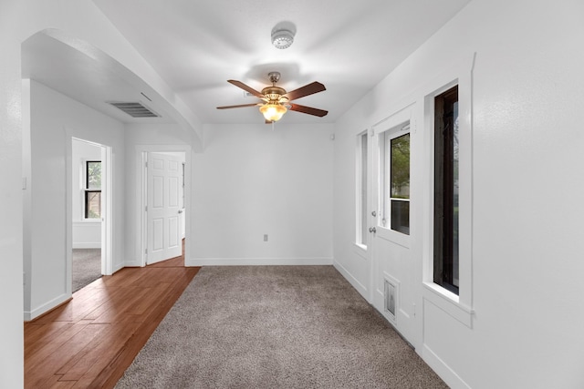 512 Gale St, Houston, TX 77009 - unfurnished room with arched walkways, ceiling fan, baseboards, and wood finished floors