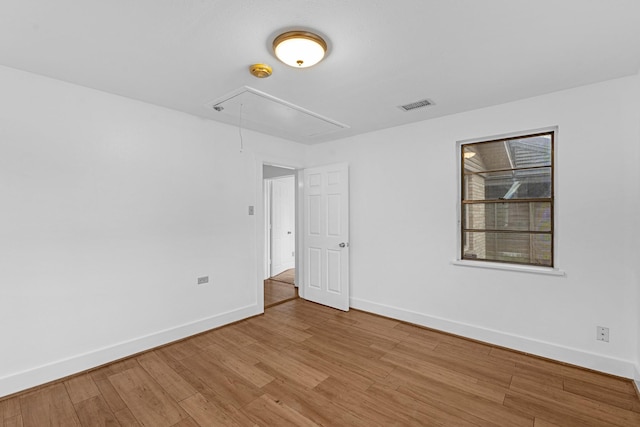 512 Gale St, Houston, TX 77009 - spare room with attic access, baseboards, light wood-style floors, and a smoke detector