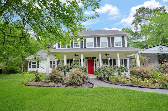 25292 Willow Creek Rd, Hockley, TX 77447 - colonial-style house featuring ceiling fan, covered porch, a front lawn, and a shingled roof