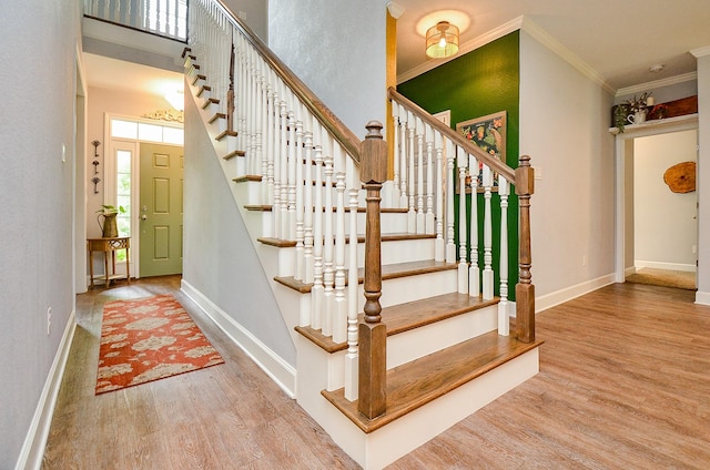 25292 Willow Creek Rd, Hockley, TX 77447 - stairs featuring wood finished floors, baseboards, crown molding, and a high ceiling