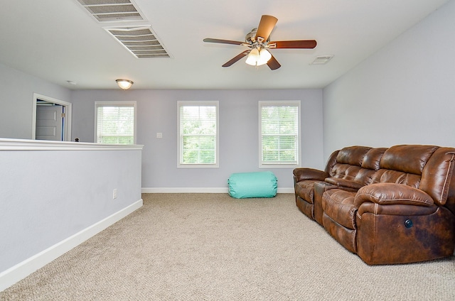 25292 Willow Creek Rd, Hockley, TX 77447 - carpeted living area featuring baseboards, healthy amount of natural light, and a ceiling fan
