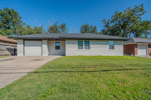 2127 Strawberry Rd, Pasadena, TX 77502 - view of front of property with brick siding, an attached garage, and concrete driveway