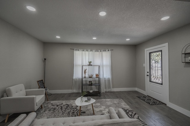 2127 Strawberry Rd, Pasadena, TX 77502 - living room with wood finished floors, recessed lighting, a textured ceiling, and baseboards