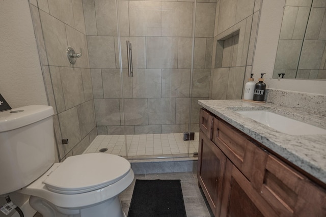 2127 Strawberry Rd, Pasadena, TX 77502 - bathroom featuring a stall shower, toilet, and vanity