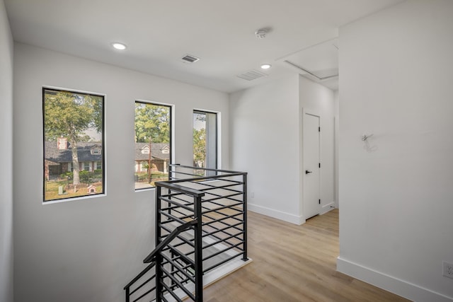 10728 Twin Oak Dr, Conroe, TX 77385 - hallway featuring an upstairs landing, baseboards, light wood-style flooring, recessed lighting, and attic access