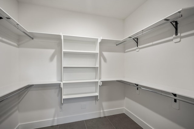 10728 Twin Oak Dr, Conroe, TX 77385 - spacious closet featuring dark tile patterned flooring