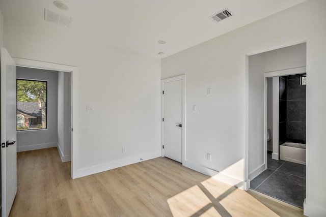 10728 Twin Oak Dr, Conroe, TX 77385 - unfurnished bedroom with light wood-type flooring and baseboards
