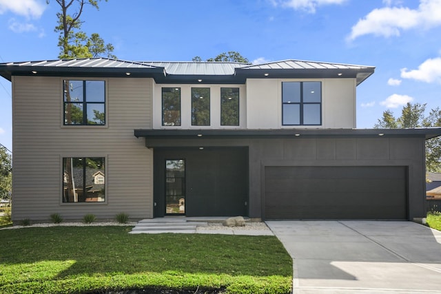 10728 Twin Oak Dr, Conroe, TX 77385 - contemporary house featuring a standing seam roof, a front yard, a garage, driveway, and metal roof