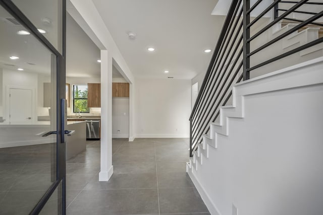 10728 Twin Oak Dr, Conroe, TX 77385 - foyer featuring stairway, baseboards, dark tile patterned flooring, and recessed lighting