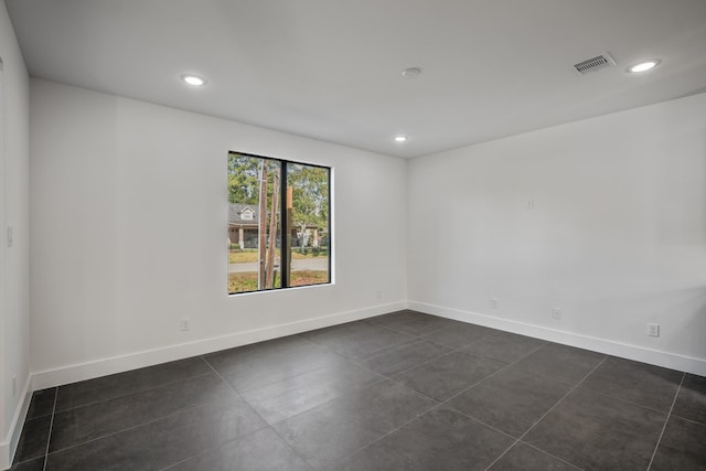 10728 Twin Oak Dr, Conroe, TX 77385 - empty room featuring recessed lighting, dark tile patterned flooring, and baseboards