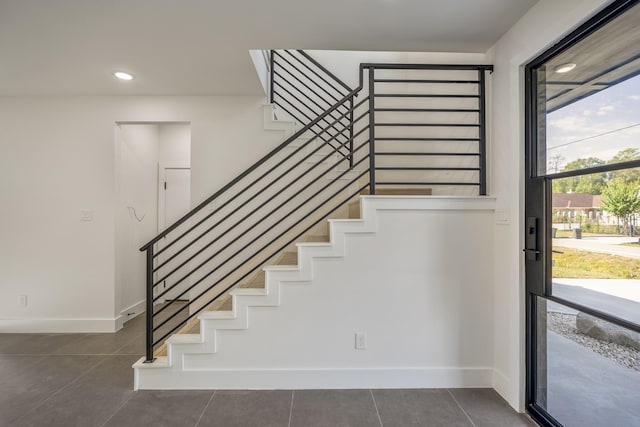 10728 Twin Oak Dr, Conroe, TX 77385 - staircase with baseboards, tile patterned floors, and recessed lighting