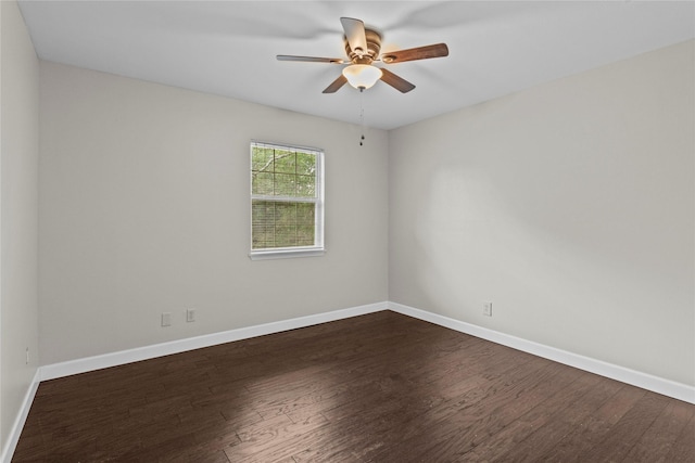 5610 Oakhaven Ln, Houston, TX 77091 - spare room featuring dark wood-type flooring, ceiling fan, and baseboards