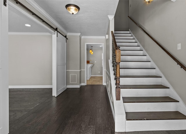 5610 Oakhaven Ln, Houston, TX 77091 - stairway with a barn door, wood finished floors, baseboards, and ornamental molding