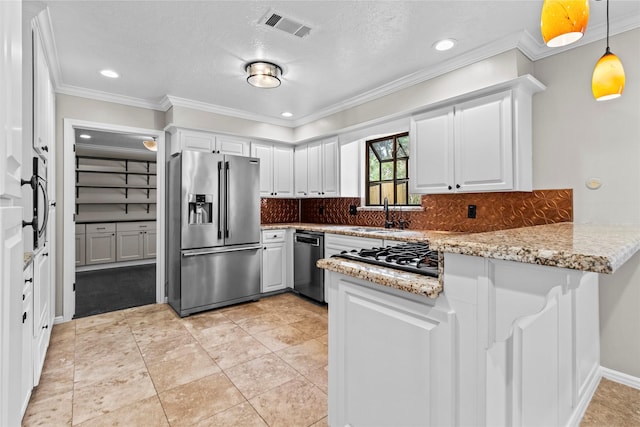 5610 Oakhaven Ln, Houston, TX 77091 - kitchen featuring appliances with stainless steel finishes, a peninsula, a sink, white cabinetry, and backsplash