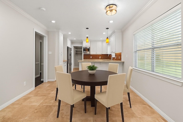 5610 Oakhaven Ln, Houston, TX 77091 - dining space with crown molding, baseboards, recessed lighting, and light tile patterned floors