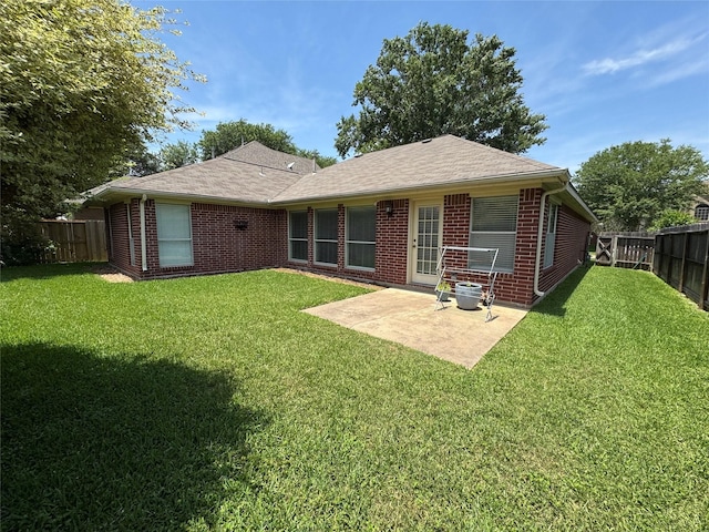 3619 Strartford Arms Ln, Sugar Land, TX 77498 - back of property with brick siding, a fenced backyard, a patio, and roof with shingles