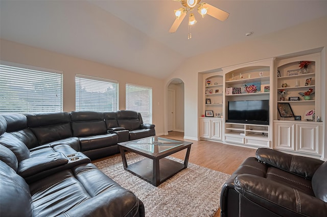 3619 Strartford Arms Ln, Sugar Land, TX 77498 - living room featuring arched walkways, ceiling fan, lofted ceiling, light wood-type flooring, and built in shelves