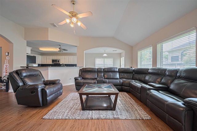 3619 Strartford Arms Ln, Sugar Land, TX 77498 - living area with arched walkways, a ceiling fan, light wood finished floors, healthy amount of natural light, and lofted ceiling