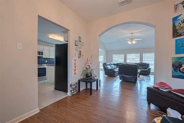 3619 Strartford Arms Ln, Sugar Land, TX 77498 - corridor featuring arched walkways, wood finished floors, and lofted ceiling