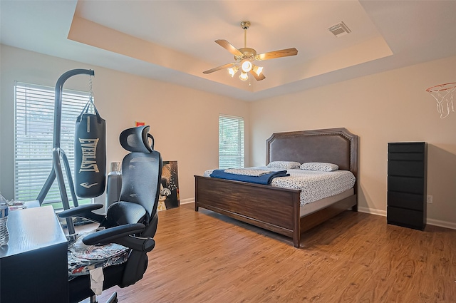 3619 Strartford Arms Ln, Sugar Land, TX 77498 - bedroom with a raised ceiling, light wood-style flooring, and ceiling fan