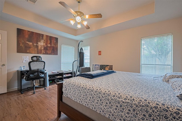 3619 Strartford Arms Ln, Sugar Land, TX 77498 - bedroom featuring wood finished floors, a tray ceiling, and a ceiling fan
