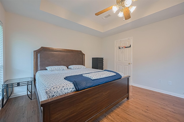 3619 Strartford Arms Ln, Sugar Land, TX 77498 - bedroom featuring a raised ceiling, wood finished floors, and a ceiling fan