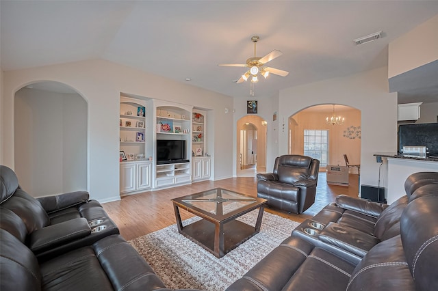 3619 Strartford Arms Ln, Sugar Land, TX 77498 - living area featuring arched walkways, a ceiling fan, light wood finished floors, a chandelier, and built in shelves