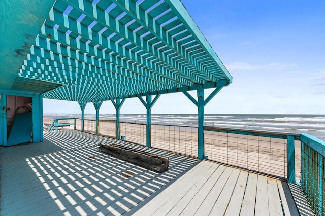 523 Blue Water Hwy, Surfside Beach, TX 77541 - wooden terrace featuring a pergola and view of water and beach