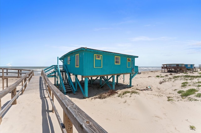 523 Blue Water Hwy, Surfside Beach, TX 77541 - dock area featuring view of water and beach and stairway