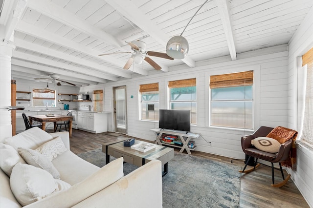 523 Blue Water Hwy, Surfside Beach, TX 77541 - living area featuring a ceiling fan, dark wood-style flooring, wooden ceiling with exposed beams, and wood walls
