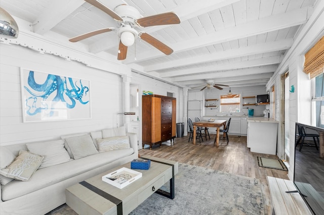 523 Blue Water Hwy, Surfside Beach, TX 77541 - living area with ceiling fan, light wood-style flooring, wooden ceiling with exposed beams, and wooden walls