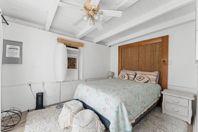 523 Blue Water Hwy, Surfside Beach, TX 77541 - bedroom with beamed ceiling, ceiling fan, and wood finished floors