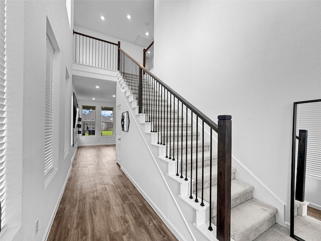 4326 Camden Springs Trl, Porter, TX 77365 - staircase featuring wood finished floors, baseboards, recessed lighting, and a high ceiling