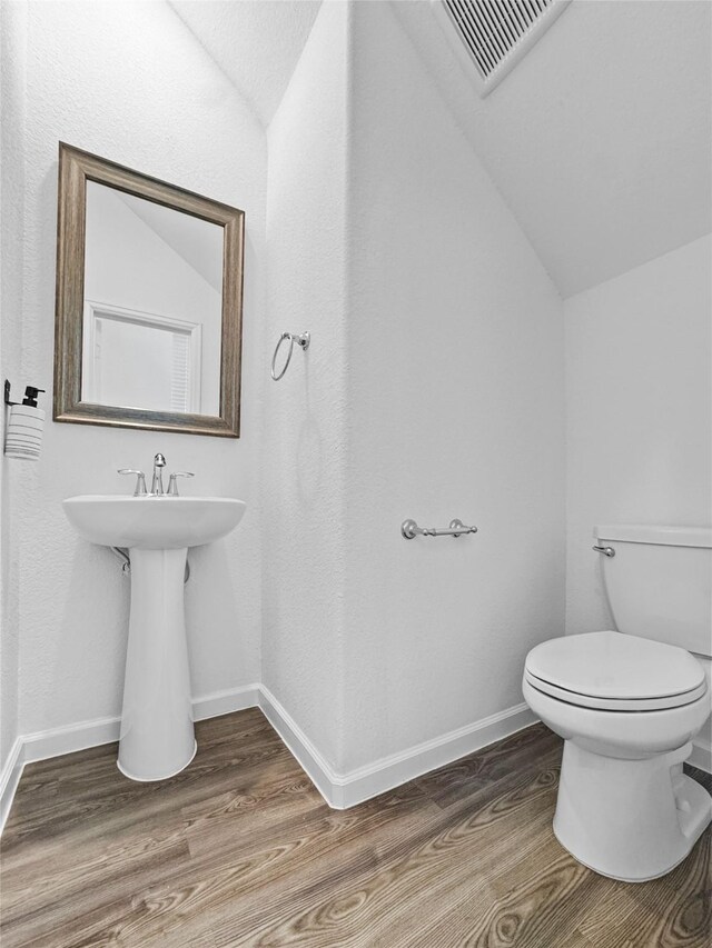 4326 Camden Springs Trl, Porter, TX 77365 - bathroom featuring vaulted ceiling, wood finished floors, toilet, and baseboards